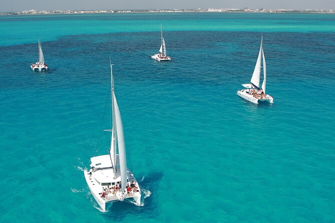 All-Inclusive Isla Mujeres Catamaran with Free Transportation - Sailing out with drinks, towels, and a short safety briefing
