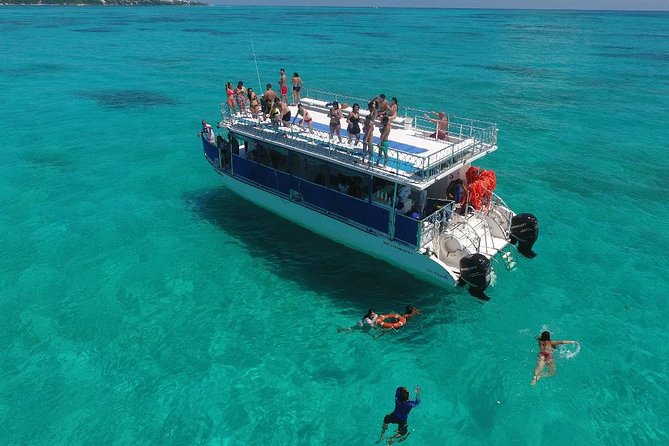 Catamaran Tour to Isla Mujeres all Included - The upper-deck jump and open-water fun