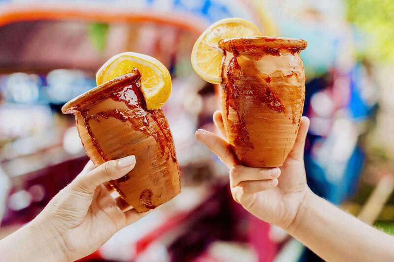 Xochimilco: Tequila tasting (unlimited) and cultural party on a boat - Xochimilco with tequila in hand
